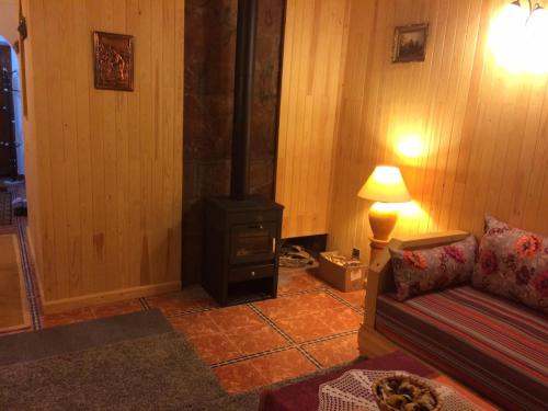 a living room with a stove and a couch at Chalet Savoyard Oukaimeden in Oukaïmeden