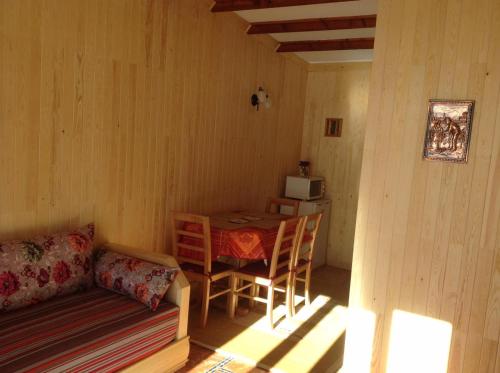 a living room with a table and a couch and a table and a tablektop at Chalet Savoyard Oukaimeden in Oukaïmeden