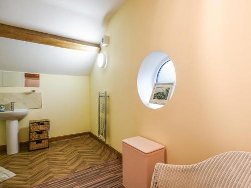 a bathroom with a sink and a window at Maltkiln Court in Bickley