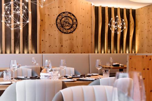 a dining room with a clock on the wall at Das Homann in Samnaun