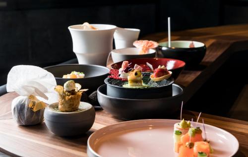 a table topped with bowls of food on a table at Das Homann in Samnaun