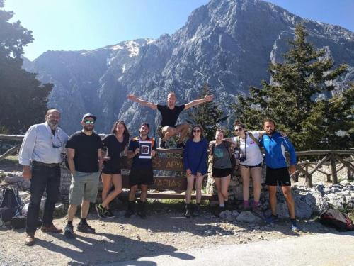 a group of people posing in front of a mountain at Hippie City Hostel in Chania Town