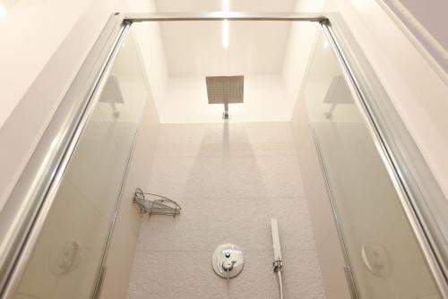 a staircase with a glass shower in a house at Maison Chene petit appartement in Bisceglie