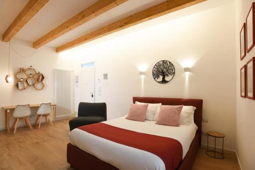 a bedroom with a large bed and a chair at Maison Chene petit appartement in Bisceglie