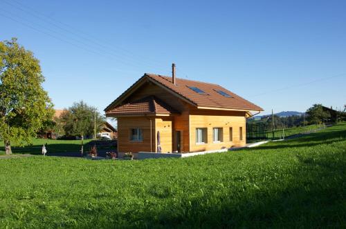 a small house with a roof on a green field at Gästehaus myHideaway in Reichenbach