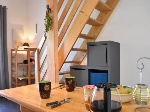 - un salon avec une table en bois et une télévision dans l'établissement Charmant Studio Mezzanine - Climatisé, Terrasse BBQ, Proche Plage et Commerces - 4 Couchages - FR-1-229-809, à Gruissan