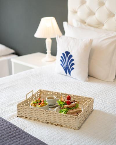 a tray of food on top of a bed at Greco Hotel in Búzios