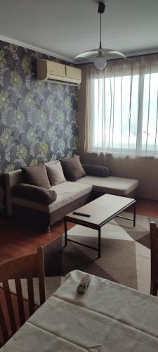 a living room with a couch and a table at Ivka in Gabrovo