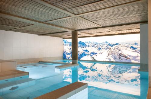 a swimming pool with a view of a mountain at TERRESENS - Le Snoroc in Aime-La Plagne