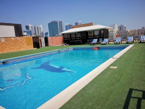 a large swimming pool on top of a building at Diva Hotel in Manama