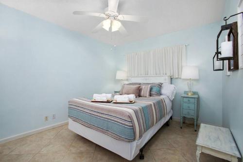 a bedroom with a bed with two towels on it at Beachfront Sunrise  in Galveston