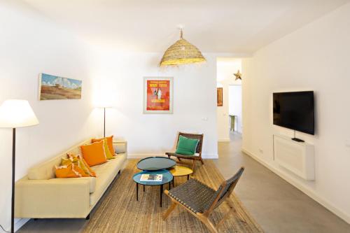a living room with a couch and a table at Casa da Tavira in Tavira