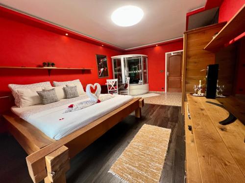 a bedroom with red walls and a large bed at Privát Adriana in Kremnica