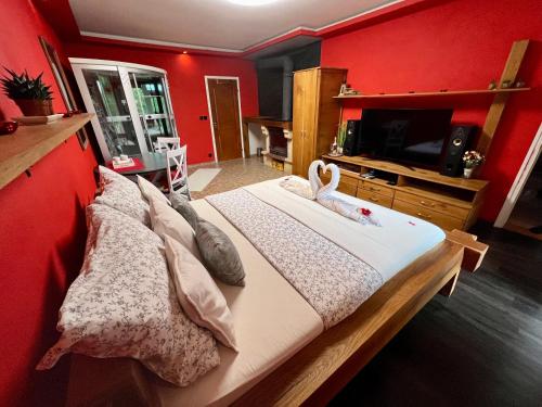 a bedroom with a large bed with a red wall at Privát Adriana in Kremnica