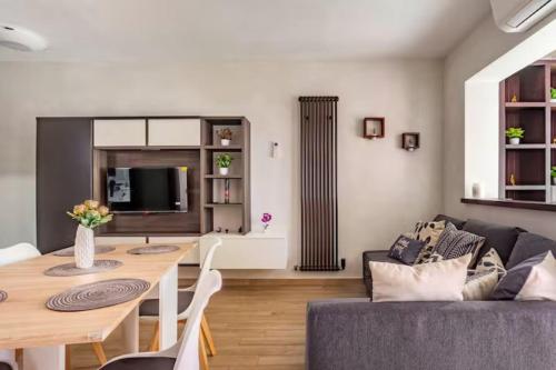 a living room with a table and a couch at Old Lighthouse - Beach Apartment - Fiumicino Airport in Fiumicino