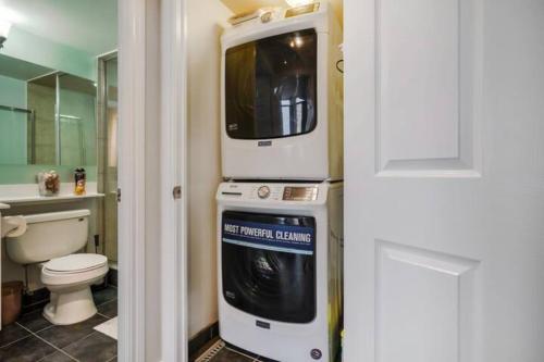 a bathroom with a microwave on top of a washing machine at Luxurious Condominium near Celebration Square in Mississauga