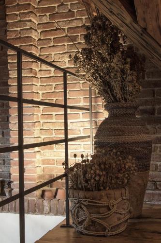 a large vase sitting next to a brick wall at Penzion Ve stoleti in Loděnice
