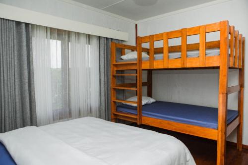 a bedroom with two bunk beds and a bed at Anna Beach Village in Ponta do Ouro