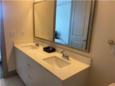 a bathroom with two sinks and a large mirror at Resort Style Apartments in Spring, TX in Spring
