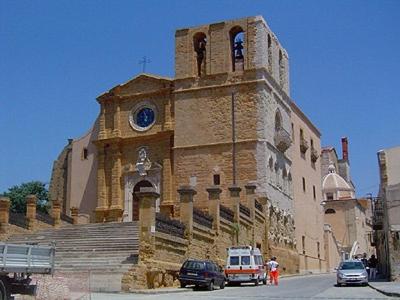 a building with a clock on the side of it at Home Holiday Casanica in Agrigento