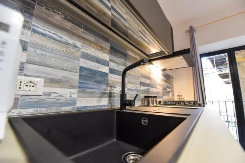 a kitchen with a sink and a counter top at Home Holiday Casanica in Agrigento