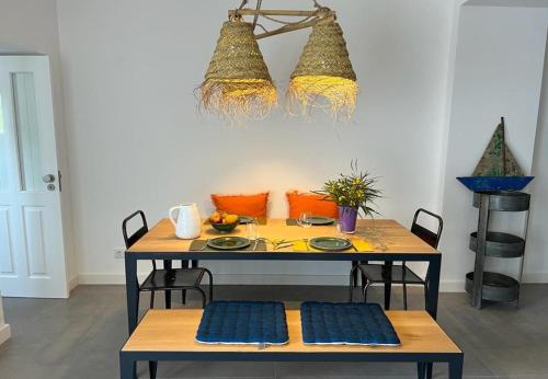 a dining table with two chairs and a tableweredotentotent at Casa da Tavira in Tavira