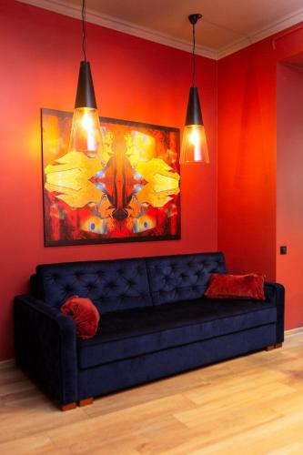 a couch in a room with a painting on the wall at Apartments Lux in city center Lviv in Lviv