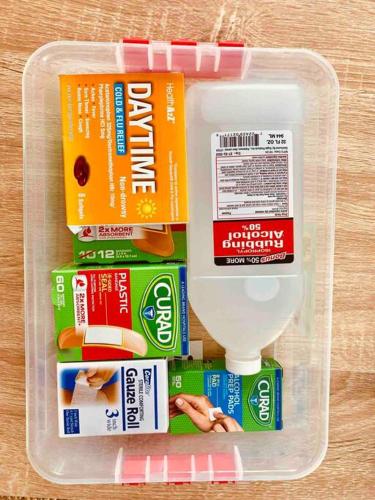 a plastic container filled with toothushes and toothpaste and a toilet at Luxury home near Disney land. Entire place! in Orange