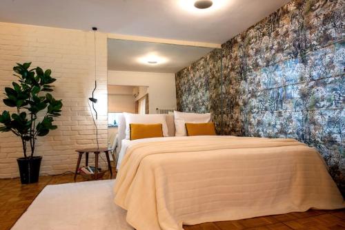 a bedroom with a large bed with a large wall at Avant-Garde Studio in Athens