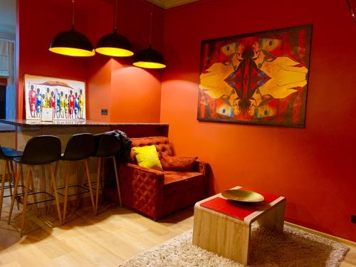 a living room with a bar with a couch and a table at Apartments Lux in city center Lviv in Lviv