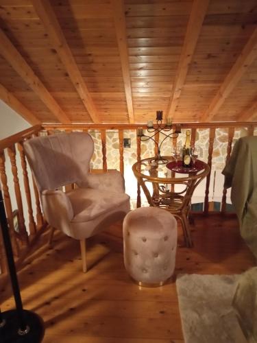 a living room with a table and a chair and a glass table at Luxury Villas Chrysa Private Pool & Spa in Nafplio