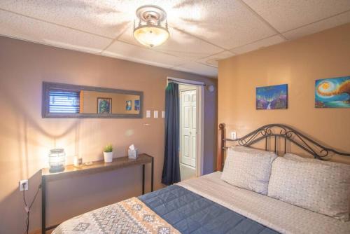 a bedroom with a bed and a light on the ceiling at The Cub Cottage in North Pole AK in North Pole