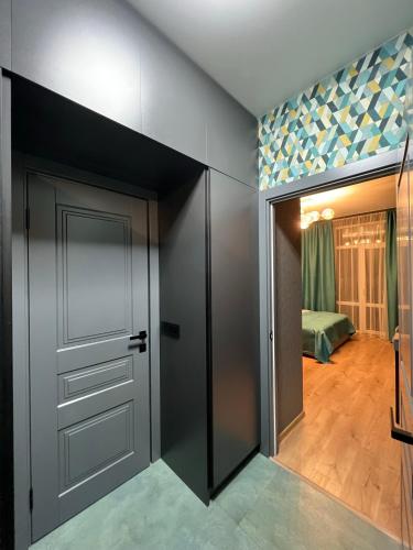 a room with a closet with a door and a bedroom at Apartments Lux in city center Lviv in Lviv