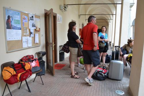 a group of people standing in a hallway with luggage at Il Chiostro Hostel and Hotel in Alessandria