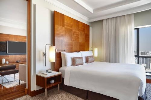 a hotel room with a large bed and a window at Renaissance São Paulo Hotel in São Paulo