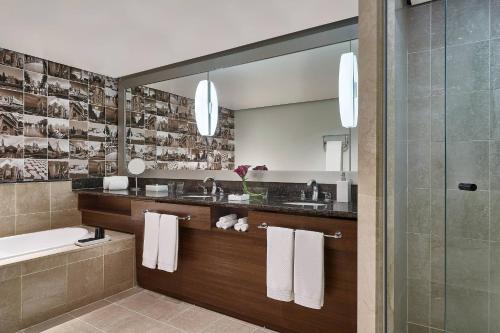 a bathroom with two sinks and a mirror at Renaissance São Paulo Hotel in Sao Paulo