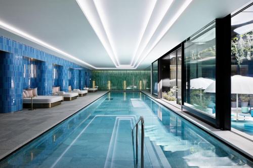 a swimming pool in a hotel with blue tiles at W Osaka in Osaka