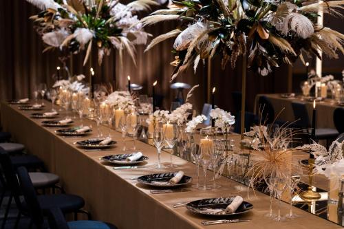 a long table with glasses and plates of food at W Osaka in Osaka