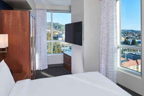 a hotel room with a bed and a large window at Residence Inn By Marriott Berkeley in Berkeley