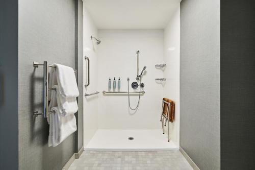 a white bathroom with a shower and a sink at Residence Inn By Marriott Berkeley in Berkeley