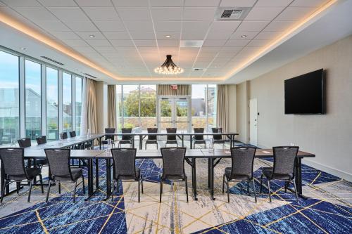 a conference room with a table and chairs and a flat screen tv at Residence Inn By Marriott Berkeley in Berkeley