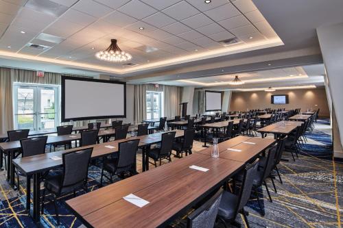 a conference room with tables and chairs and a projection screen at Residence Inn By Marriott Berkeley in Berkeley