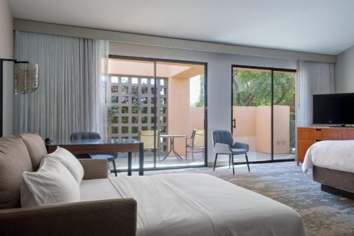 a hotel room with a bed and a living room at The Westin Rancho Mirage Golf Resort & Spa in Rancho Mirage