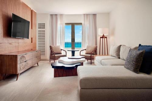 a living room with a couch and a television at JW Marriott Cancun Resort & Spa in Cancún