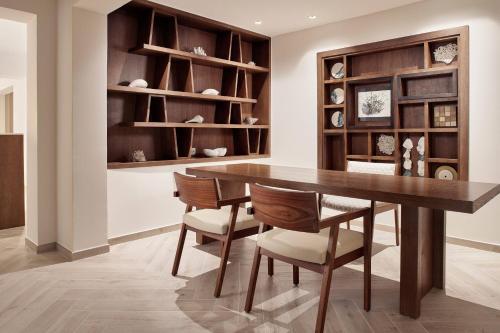 a dining room with a wooden table and chairs at JW Marriott Cancun Resort & Spa in Cancún