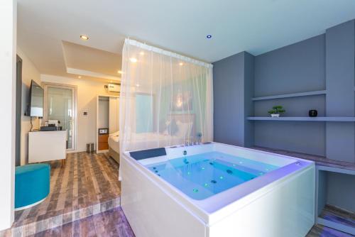 a bathroom with a large tub in a room at FUNPLACE BEACH in Himmafushi