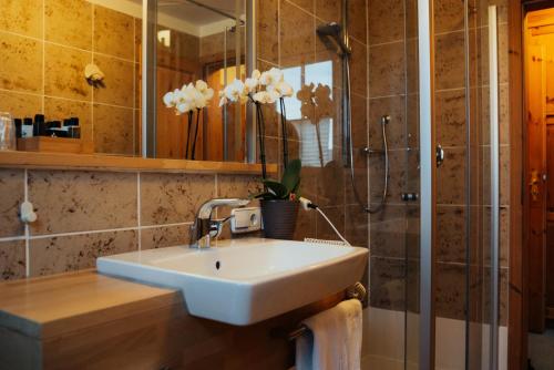 a bathroom with a white sink and a shower at Hotel Krone in Beffendorf