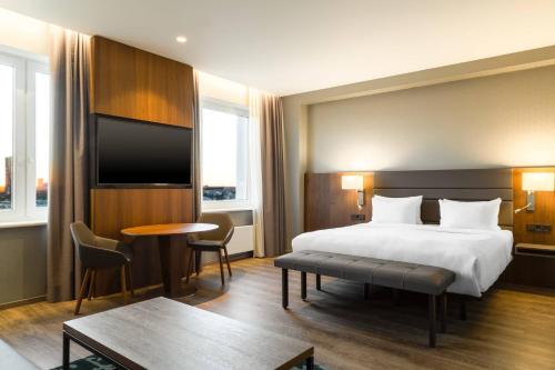 a hotel room with a bed and a table at AC Hotel by Marriott Riga in Rīga