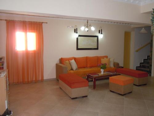 a living room with a couch and a table at Atlas Pension in Karterados