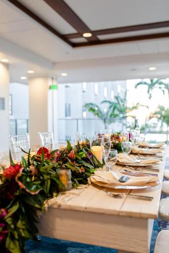 a long wooden table with flowers on it at Waikoloa Beach Marriott Resort & Spa in Waikoloa